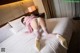 A woman laying on top of a bed in a hotel room.