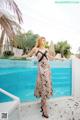 A woman standing in front of a swimming pool.