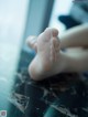 A close up of a person's bare feet on a table.