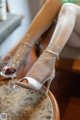 A woman sitting on a table with a glass of wine.