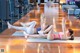 A couple of women doing yoga in a gym.