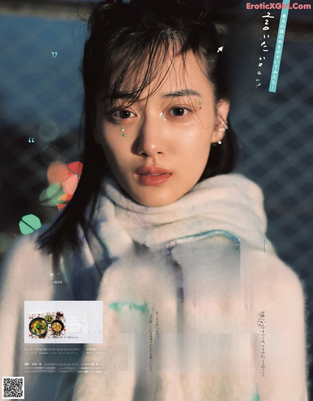 A woman in a white sweater is featured in a magazine.