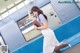 A woman in a white dress is standing on a subway train.