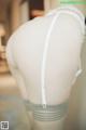 A mannequin wearing a white bra and gray stockings.